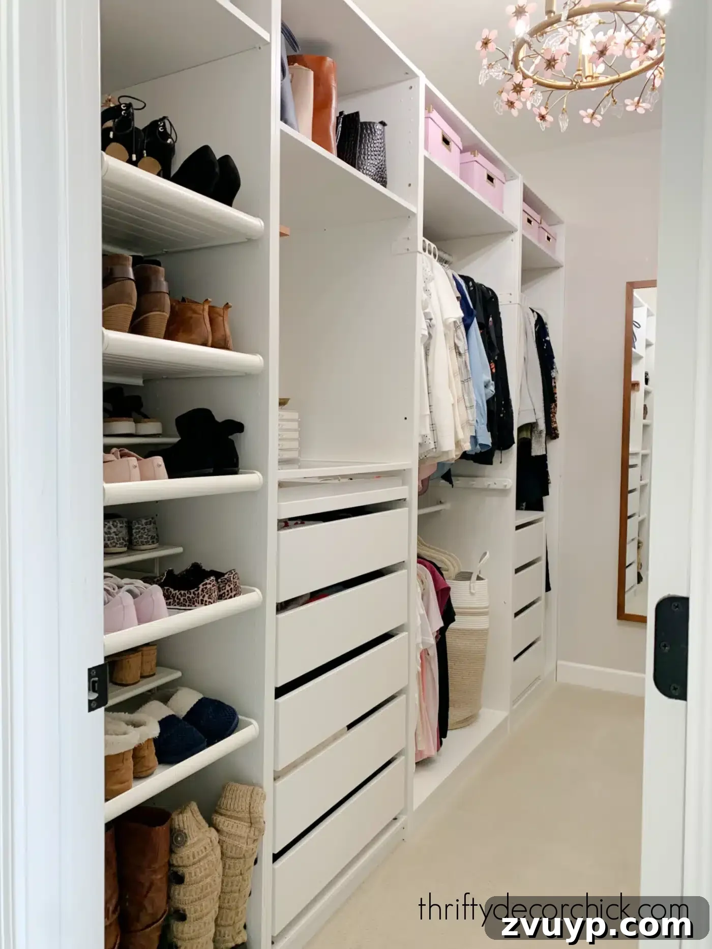 Smart DIY Upgrades for Your IKEA Pax Wardrobe 27 A simple white closet elevated by a charming flower-shaped light fixture, adding personality and a decorative touch.