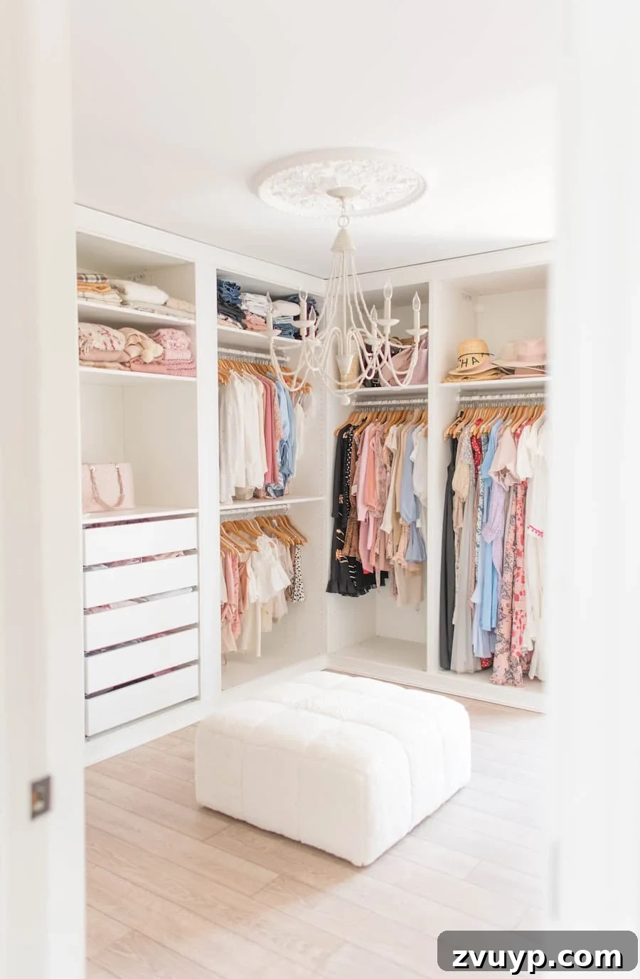 Smart DIY Upgrades for Your IKEA Pax Wardrobe 30 An all-white built-in closet system featuring a stylish ottoman bench, providing a convenient seating area for dressing.