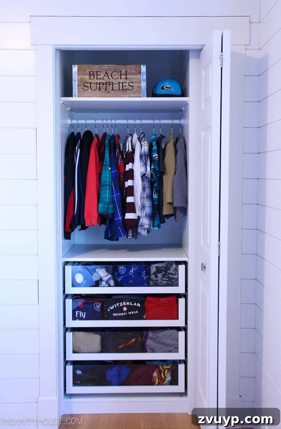 Smart DIY Upgrades for Your IKEA Pax Wardrobe 8 A small reach-in closet organized with clear drawer fronts, allowing for easy visibility of clothing and accessories.
