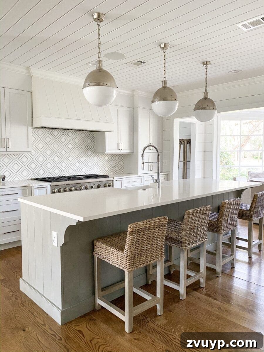 Sea Island Coastal Home Showcase 8 Dreamy coastal kitchen in Sea Island with white cabinetry, modern appliances, and elegant design details