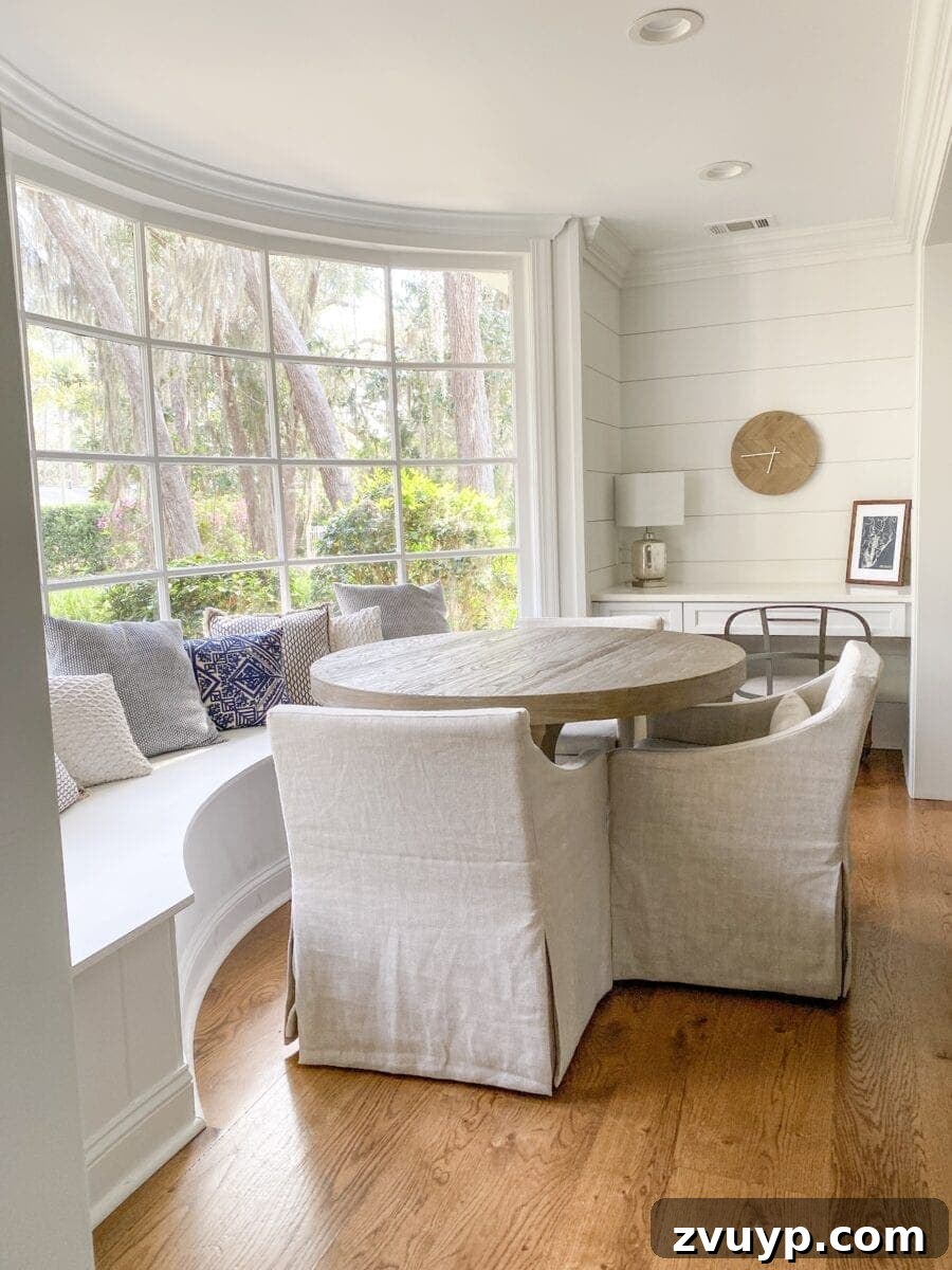 Sea Island Coastal Home Showcase 9 Charming coastal breakfast nook in Sea Island featuring a sunlit window banquette and small writing desk