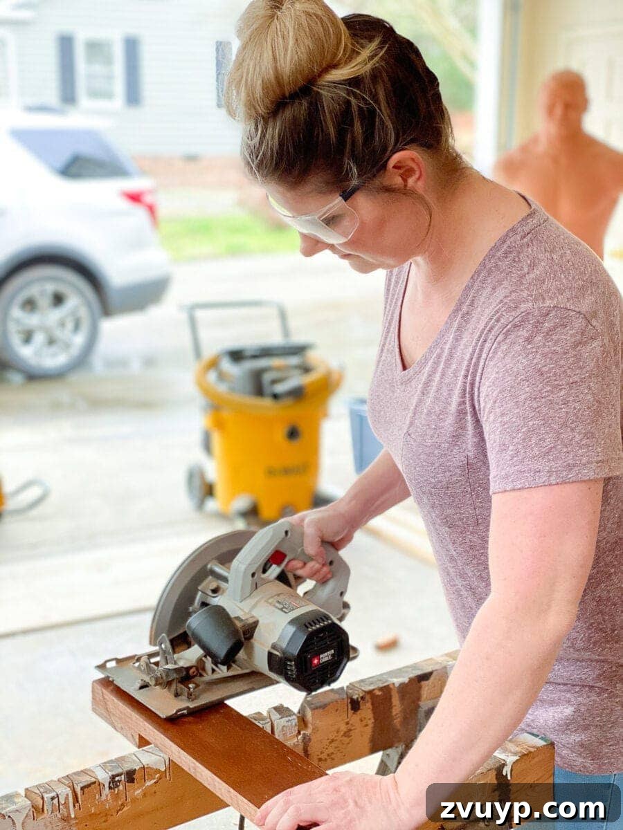 Craft a Vertical Garden from Reclaimed Wood 6 Cutting scrap wood boards with a circular saw for the vertical succulent planter frame, demonstrating precise woodworking.