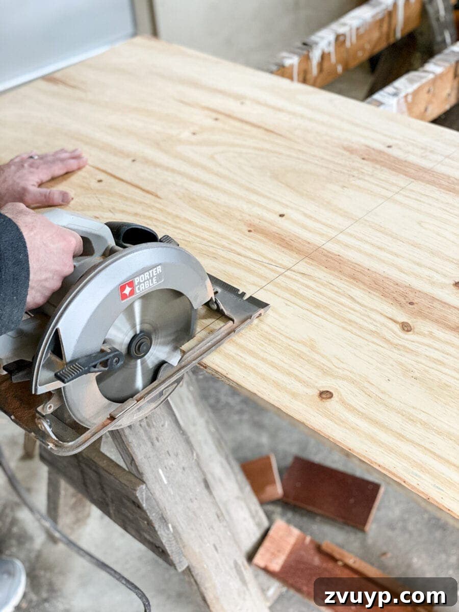 Craft a Vertical Garden from Reclaimed Wood 7 Close-up of freshly cut plywood ready for the DIY vertical wall planter, highlighting preparation steps.