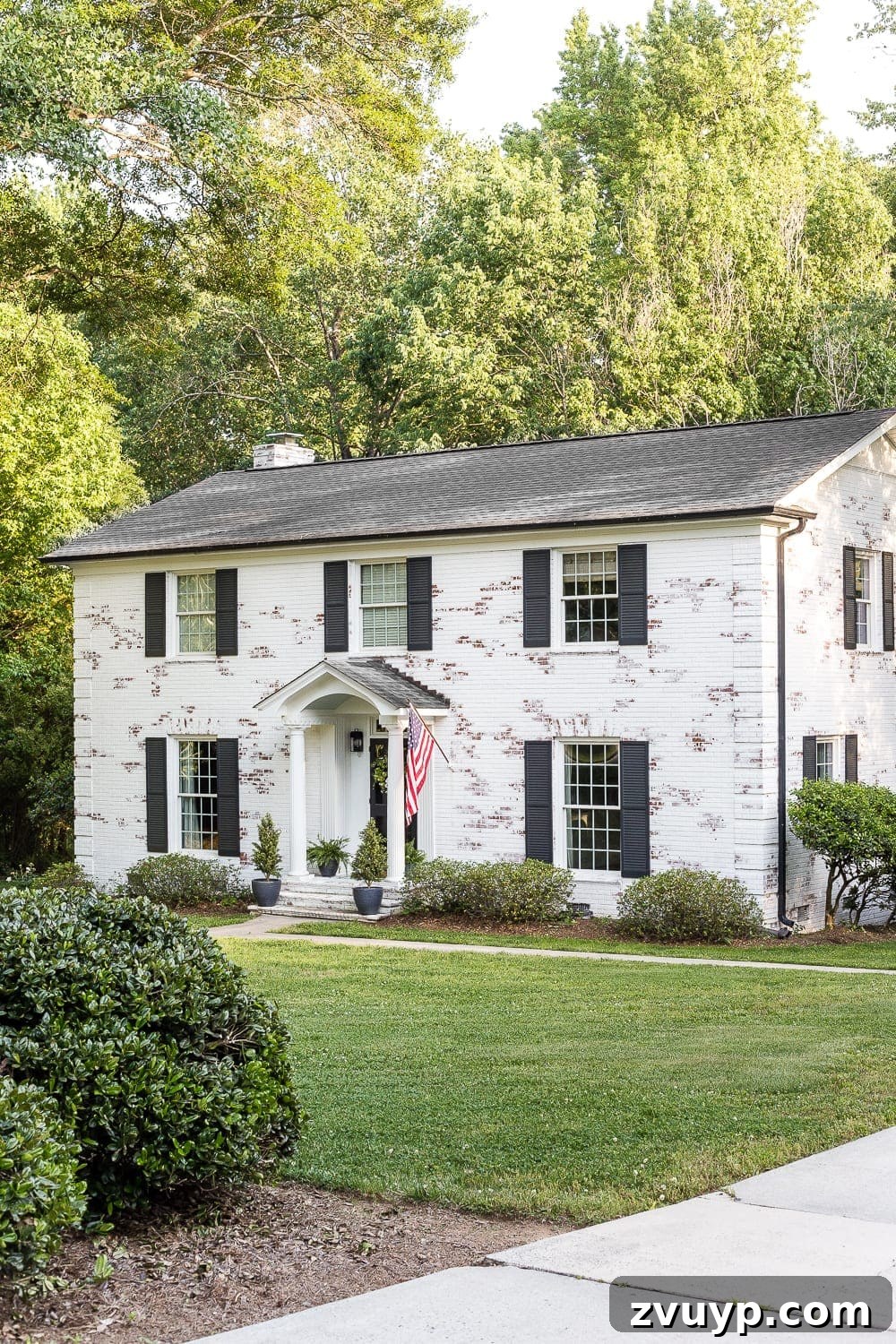 Limewashed brick colonial home exterior after renovation
