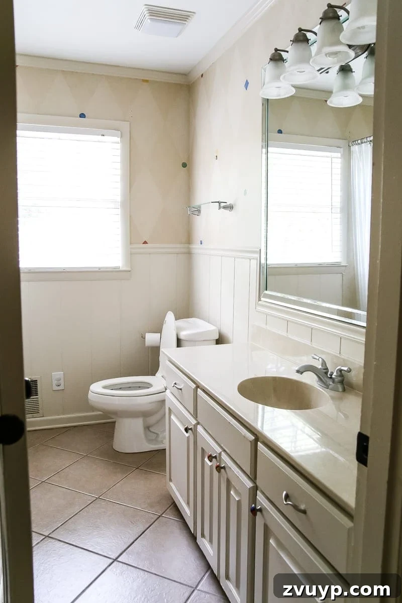 Before photo of the outdated kids' bathroom with simple fixtures