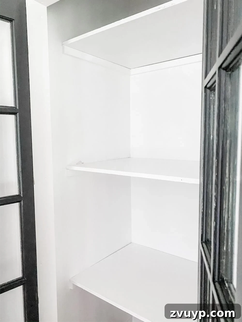 Plywood shelves installed on 1x2 braces and painted white inside the closet