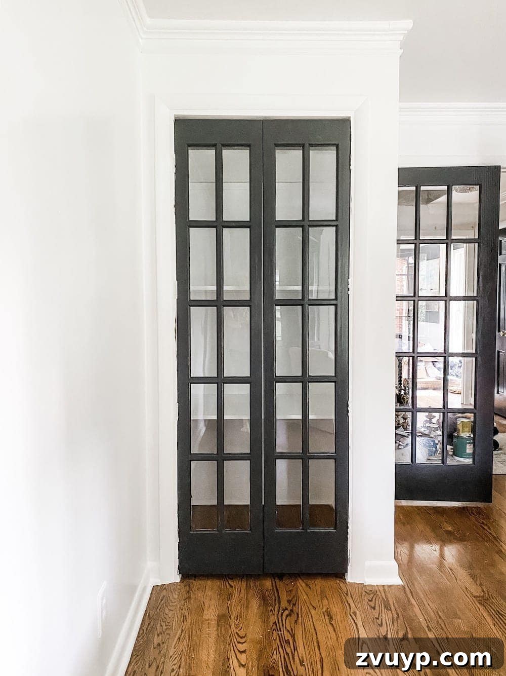Full view of the home office closet with new French doors and painted interior, awaiting organization