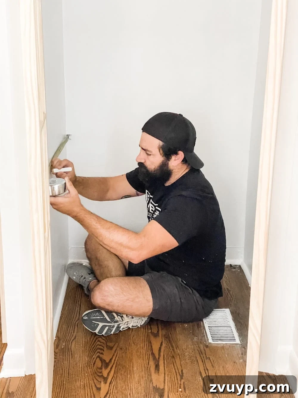 Person marking shelf placement inside a closet with a tape measure