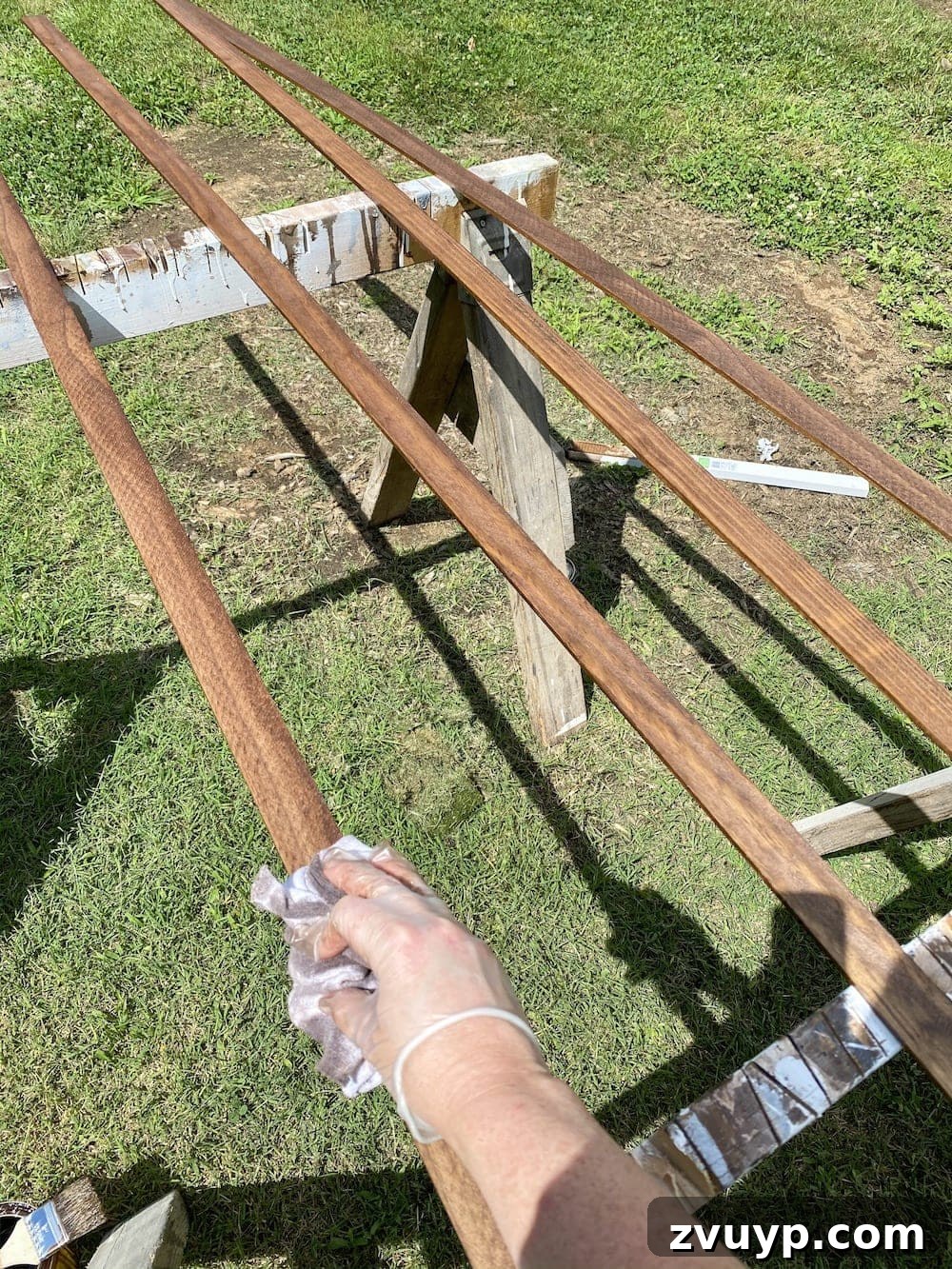 Transform a Shower Curtain into Statement Wall Art 3 Lattice strips being stained with Minwax Special Walnut for the DIY wall art frame.