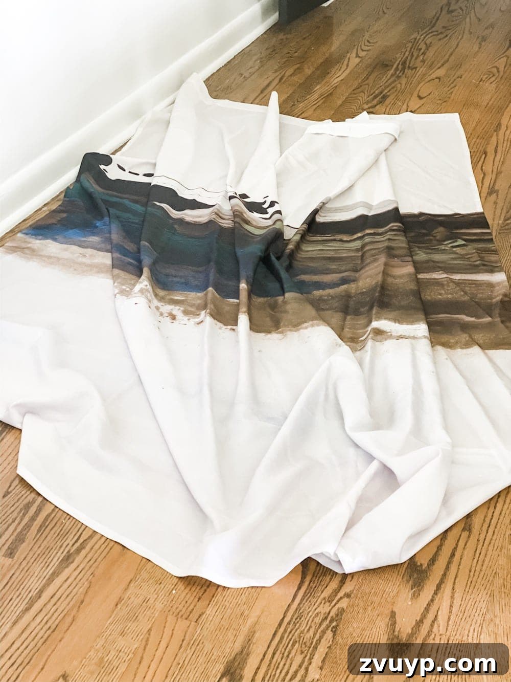 Transform a Shower Curtain into Statement Wall Art 4 Shower curtain being measured and trimmed for the large DIY wall art project.