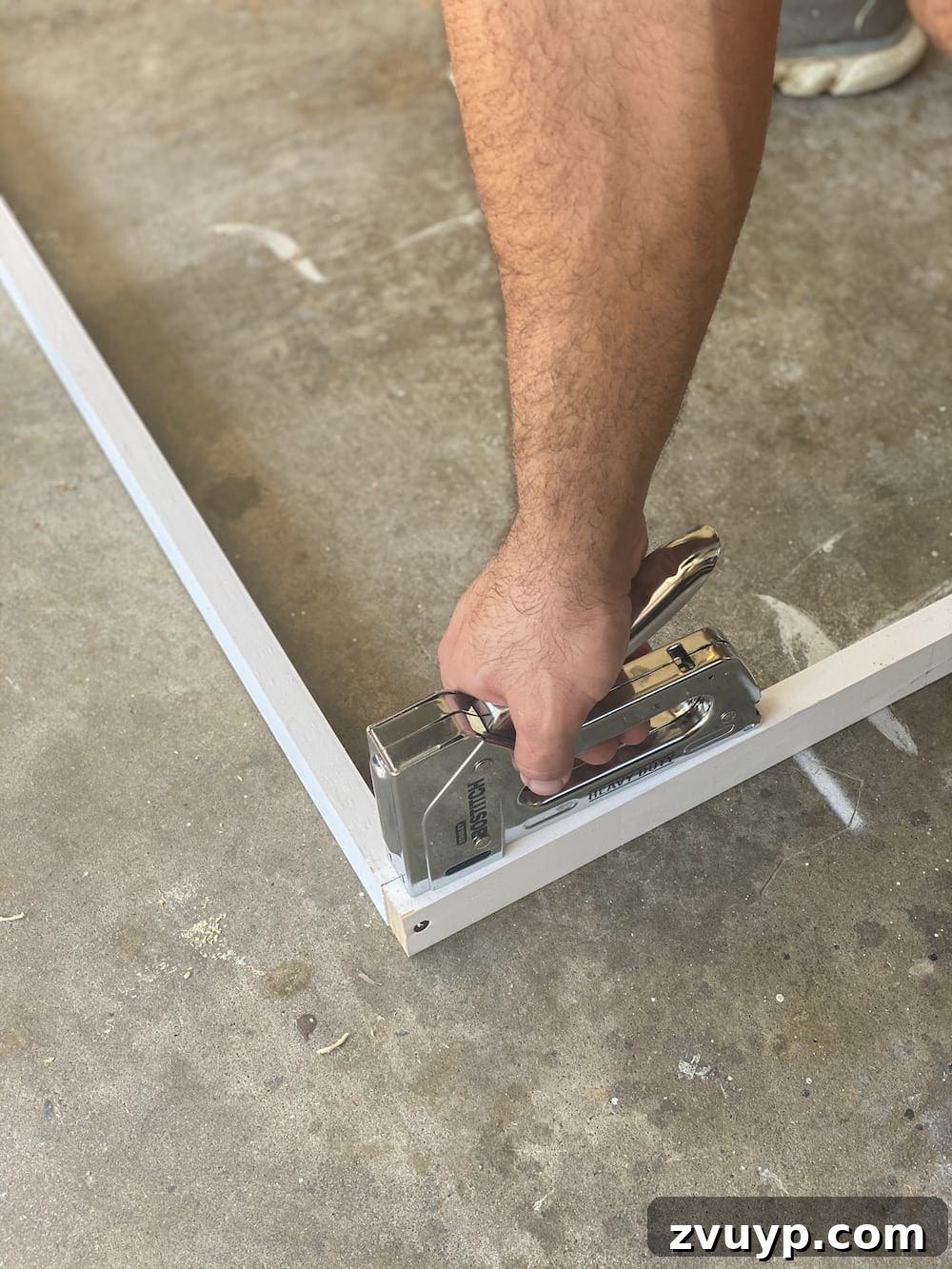 Transform a Shower Curtain into Statement Wall Art 7 Assembled internal frame for the DIY large wall art, showing secured corners and support beams.
