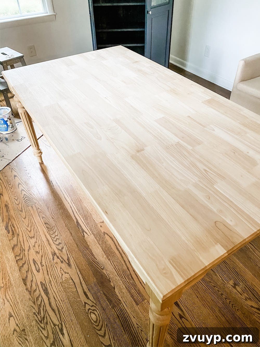 DIY Furniture Evolution: From Raw Wood to Custom Workspaces 2 A beautifully stained solid wood office work table, customized from an unfinished piece, sits elegantly in a home office setting. It showcases a budget-friendly DIY furniture customization project.