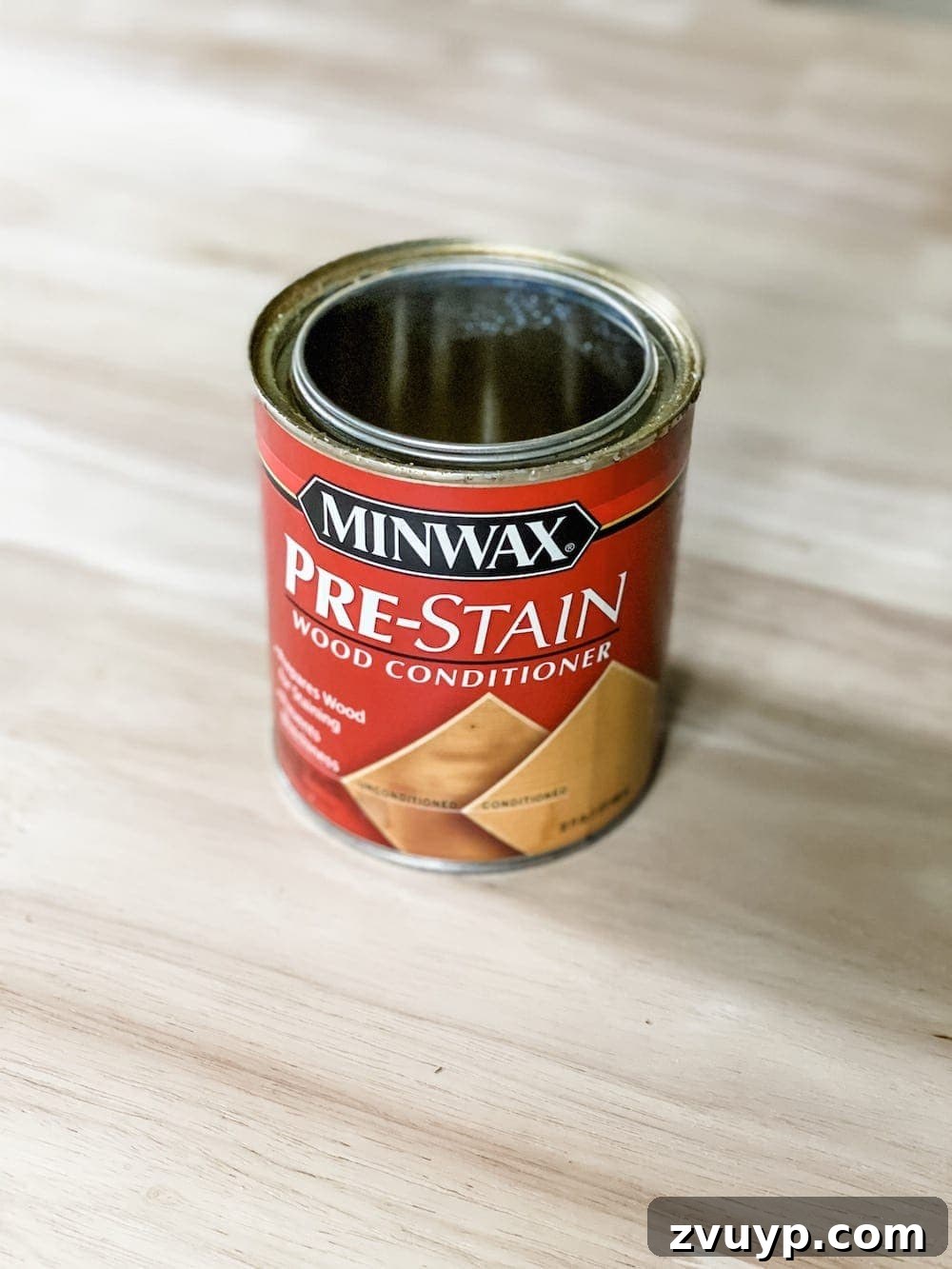 DIY Furniture Evolution: From Raw Wood to Custom Workspaces 4 Applying Minwax Pre-Stain Wood Conditioner to an unfinished wood table to ensure even stain application and prevent blotchiness.