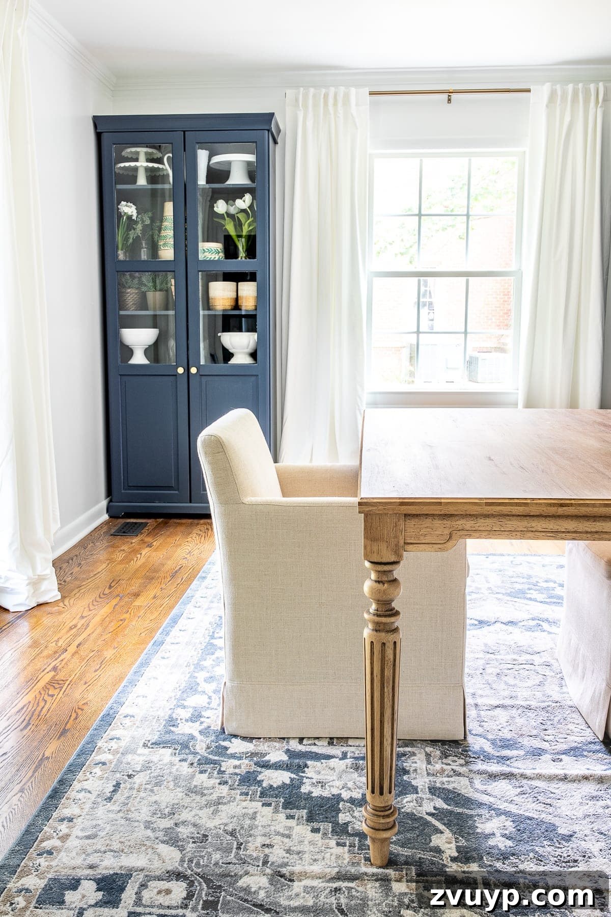 DIY Furniture Evolution: From Raw Wood to Custom Workspaces 6 A finished office work table, stained in Minwax Special Walnut, serves as the centerpiece of a newly decorated home office, flanked by rolling armchairs and a patterned rug.