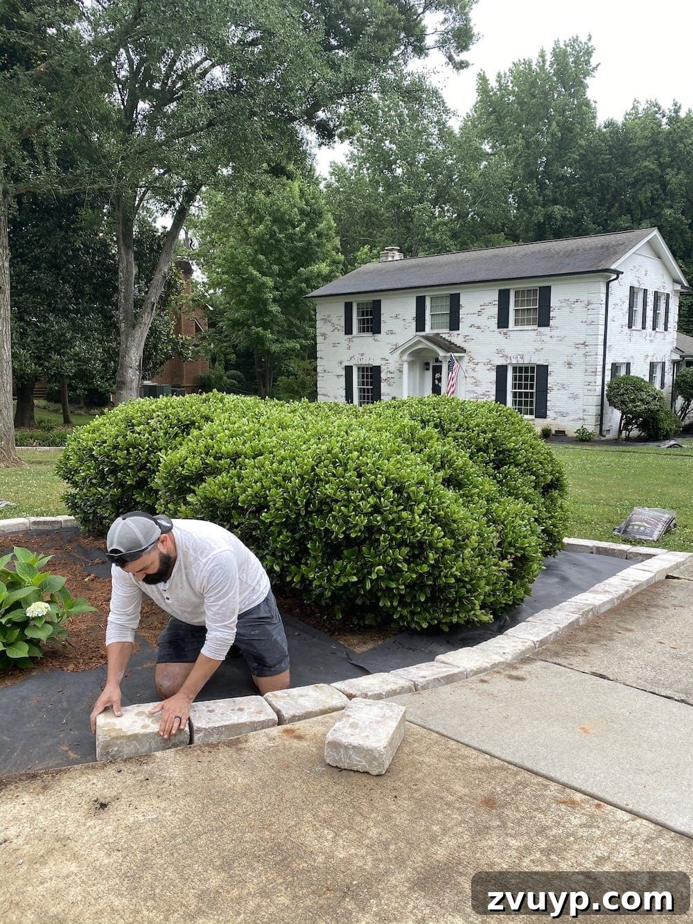 Front Flower Bed DIY Transformation 15 Laying Tremron Munich stone blocks in Sand Dune as edger stones around the newly planted flower bed.