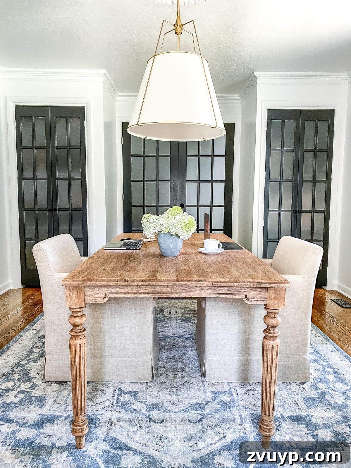 Our Dream Home Office Unveiled 6 Modern home office with light walls, navy accents, and stylish decor elements after conversion