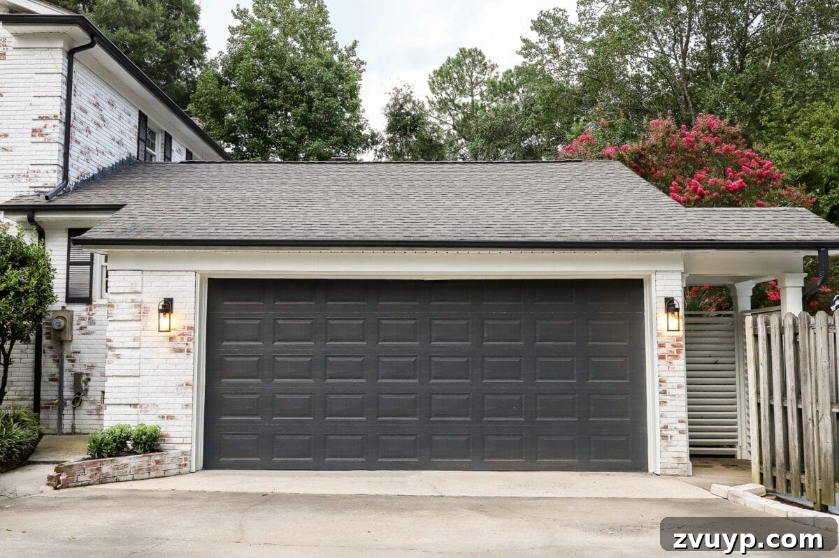 Revamping Our Garage Exterior with Bright New Lighting 9 The garage door painted black, providing a temporary yet stylish update to the exterior.