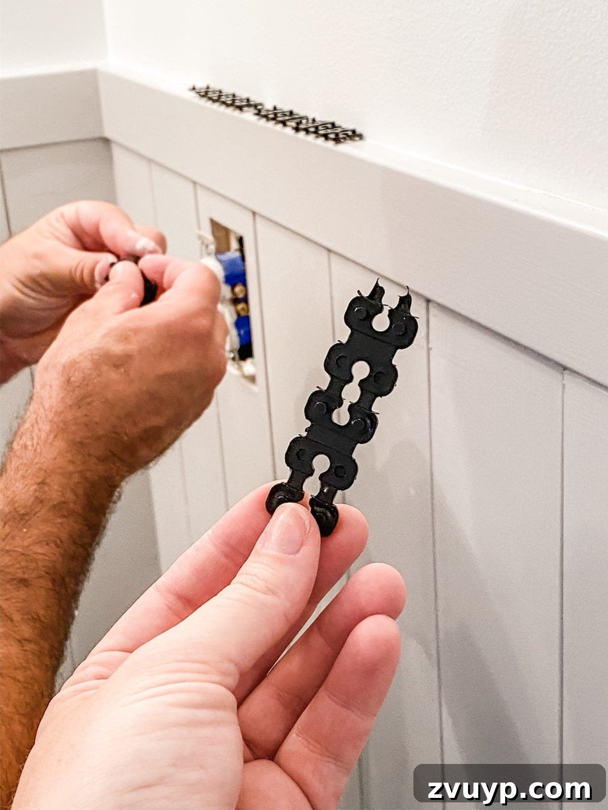 Effortless Bathroom Makeover: DIY Vertical Shiplap Wainscoting 12 Installing outlet spacers to bring electrical outlets flush with vertical shiplap wainscoting.