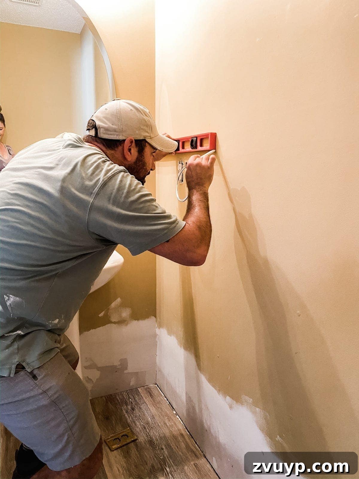 Effortless Bathroom Makeover: DIY Vertical Shiplap Wainscoting 5 Marking a wall with a level to ensure straight shiplap placement.
