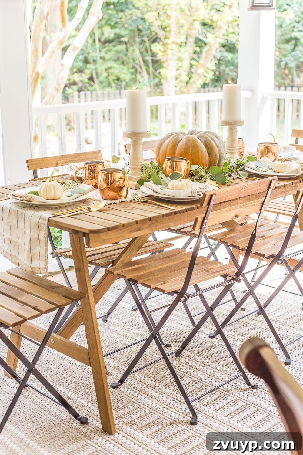 Create Your Cozy Fall Haven: DIY Decor Ideas 15 outdoor dining table decorated for fall with pumpkin centerpiece, eucalyptus, and copper
