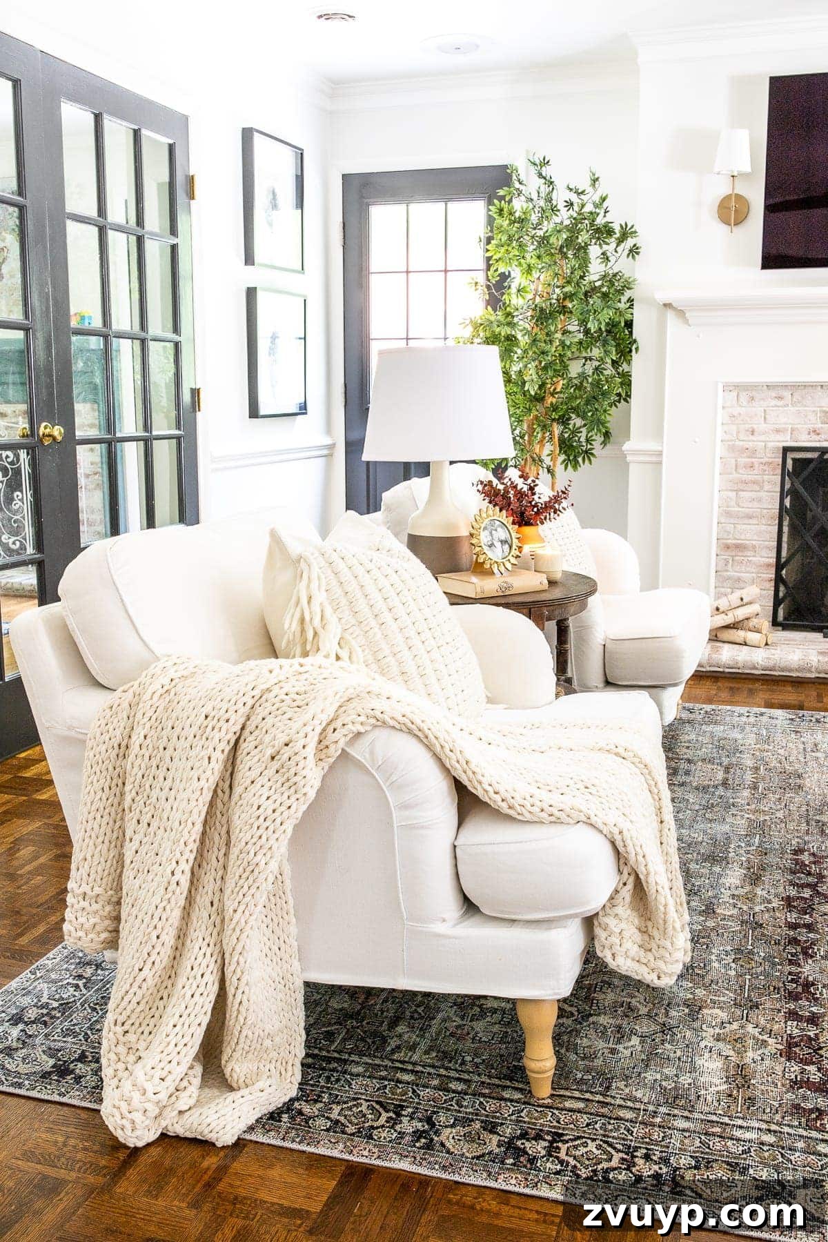 An Earthy Fall Living Room and My Go-To Budget Fall Decor Capsule 7 Accent chairs in a living room adorned with a soft cable knit throw blanket and matching pillows, inviting ultimate comfort and relaxation.