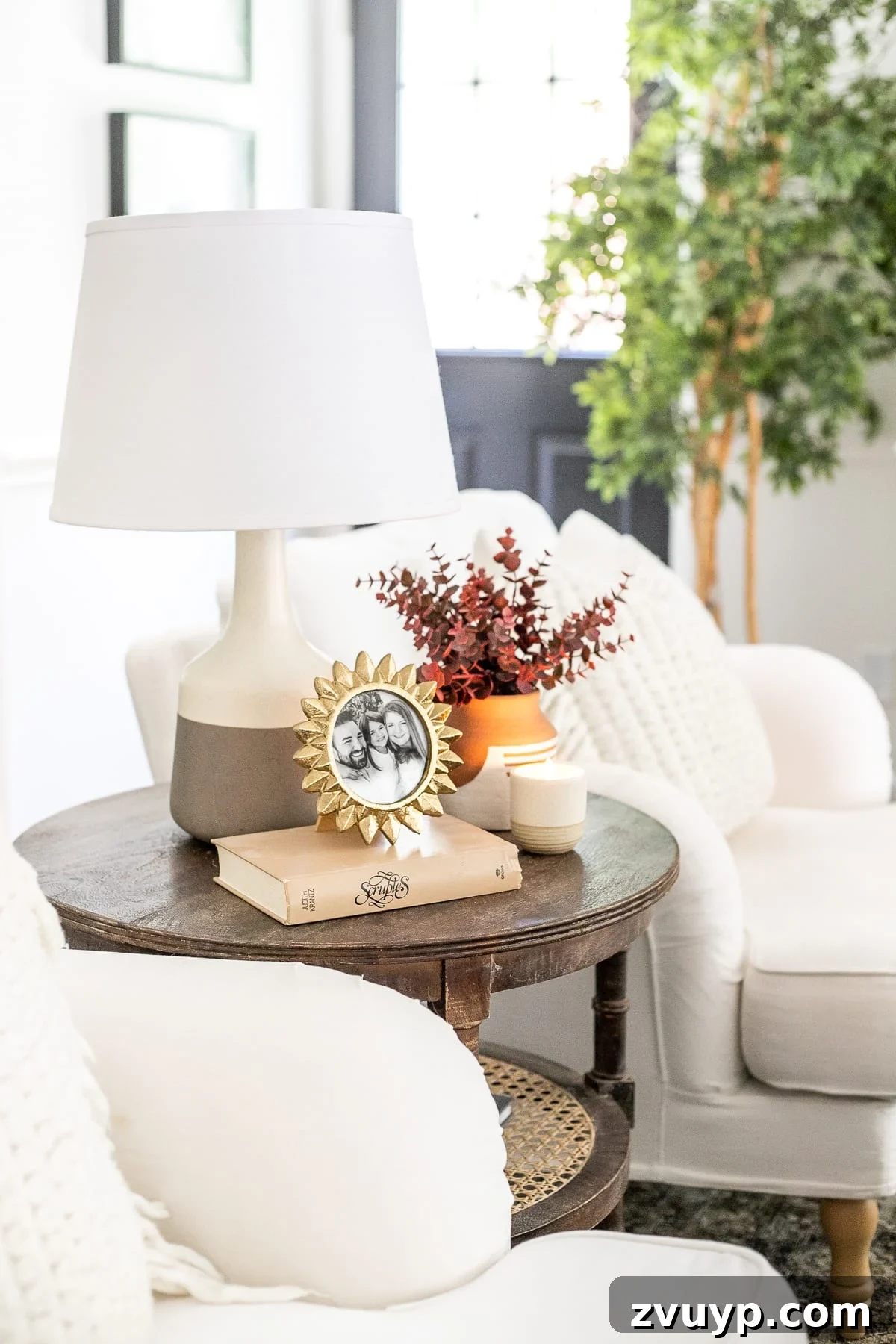An Earthy Fall Living Room and My Go-To Budget Fall Decor Capsule 5 Elegant living room end table featuring a vase filled with vibrant fall stems, adding a touch of seasonal beauty to the space.