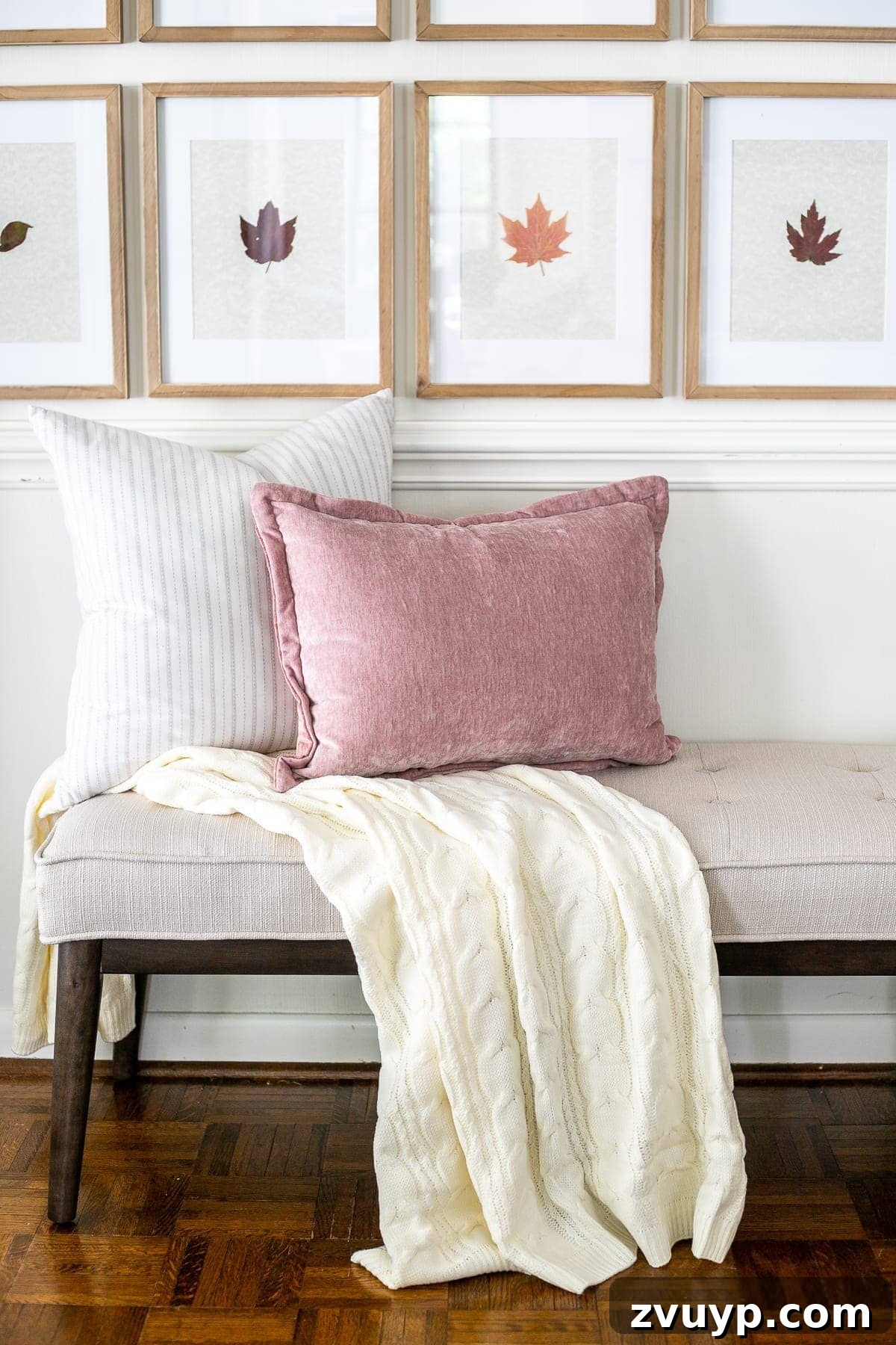 Pressed Leaf Gallery Wall: Autumn Entry Decor 9 Stylishly arranged entryway bench with framed pressed fall leaves on the wall and a mix of neutral and blush throw pillows