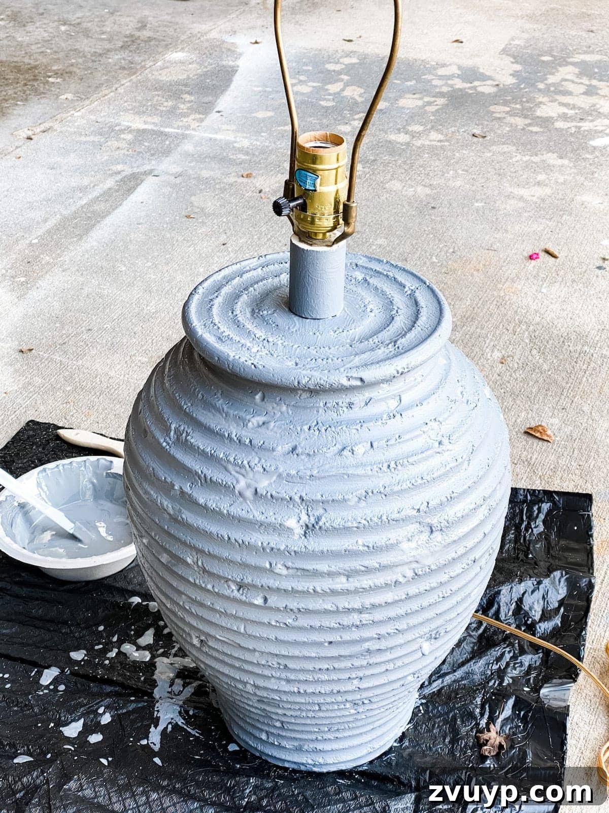 DIY Designer Terra Cotta Table Lamp 4 Table lamp base fully painted in a solid medium gray coat, ready for the next textured layer.