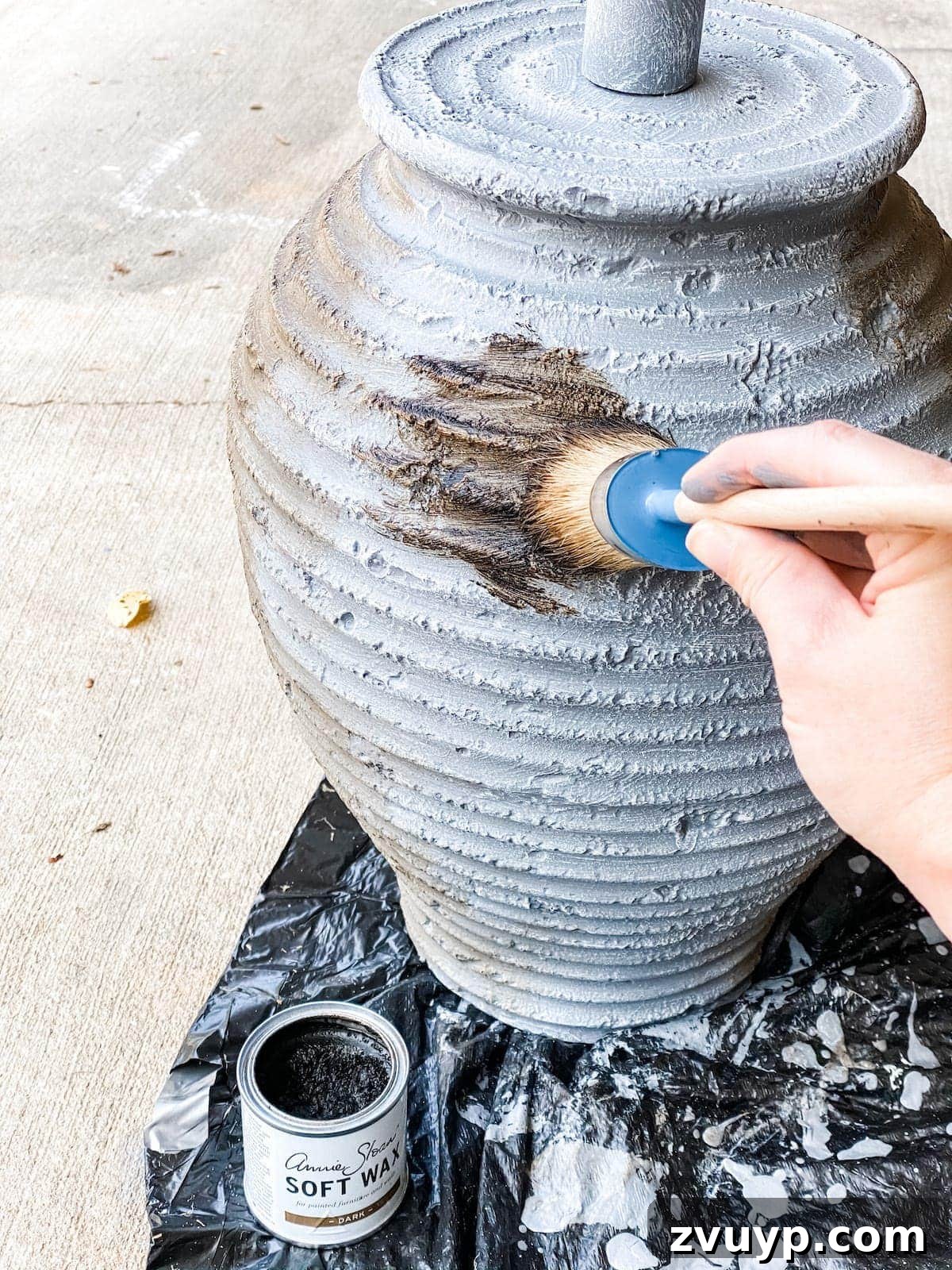 DIY Designer Terra Cotta Table Lamp 7 Detailed view of the dark wax finish being applied to the gray painted and dry-brushed lamp, creating an antiqued effect.