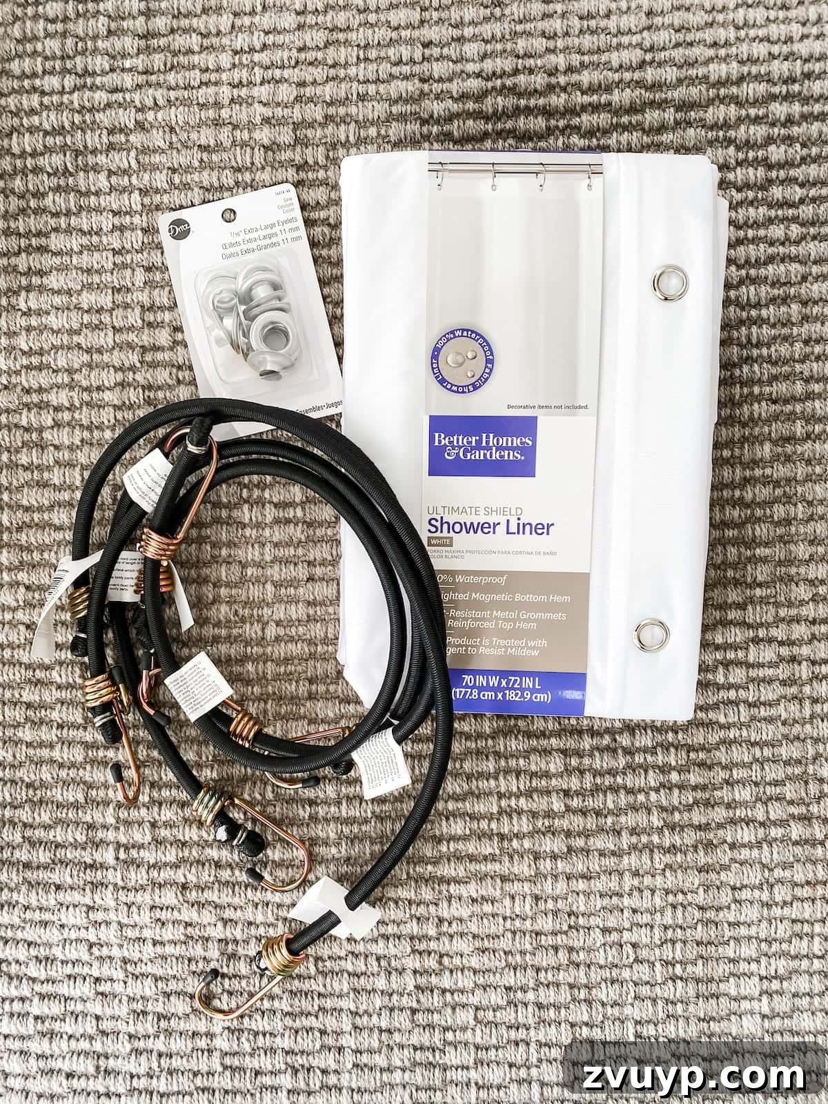 Outdoor Movie Screen Supplies Supplies for DIY outdoor movie screen including shower curtain, eyelets, and bungee cords