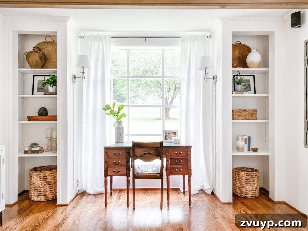 McNay Home Modern Coastal Living Revealed 15 After image of renovated living room showing built-in shelves and a functional desk area by the window