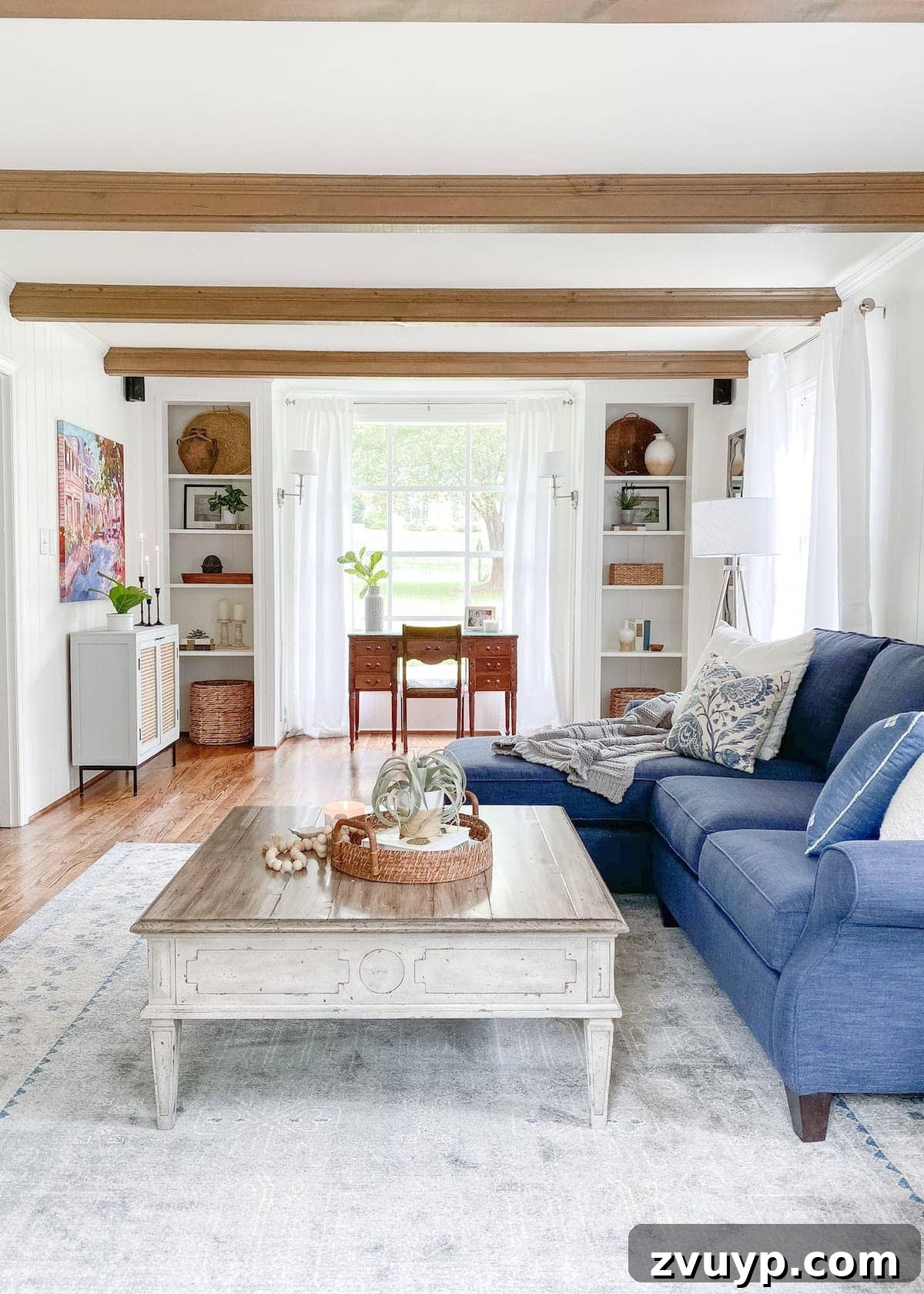McNay Home Modern Coastal Living Revealed 5 After image of a modern coastal living room showing the divided layout with a designated workspace