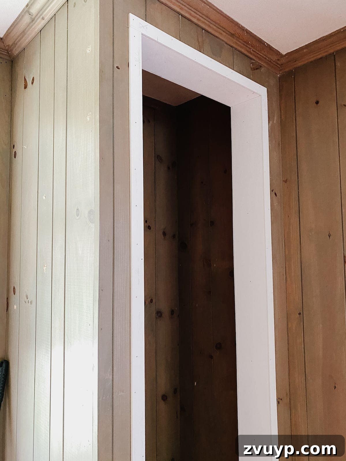 Transform Closets into Seamless Built-In Shelving 12 Applying caulk to the framed closet doorway for a smooth finish