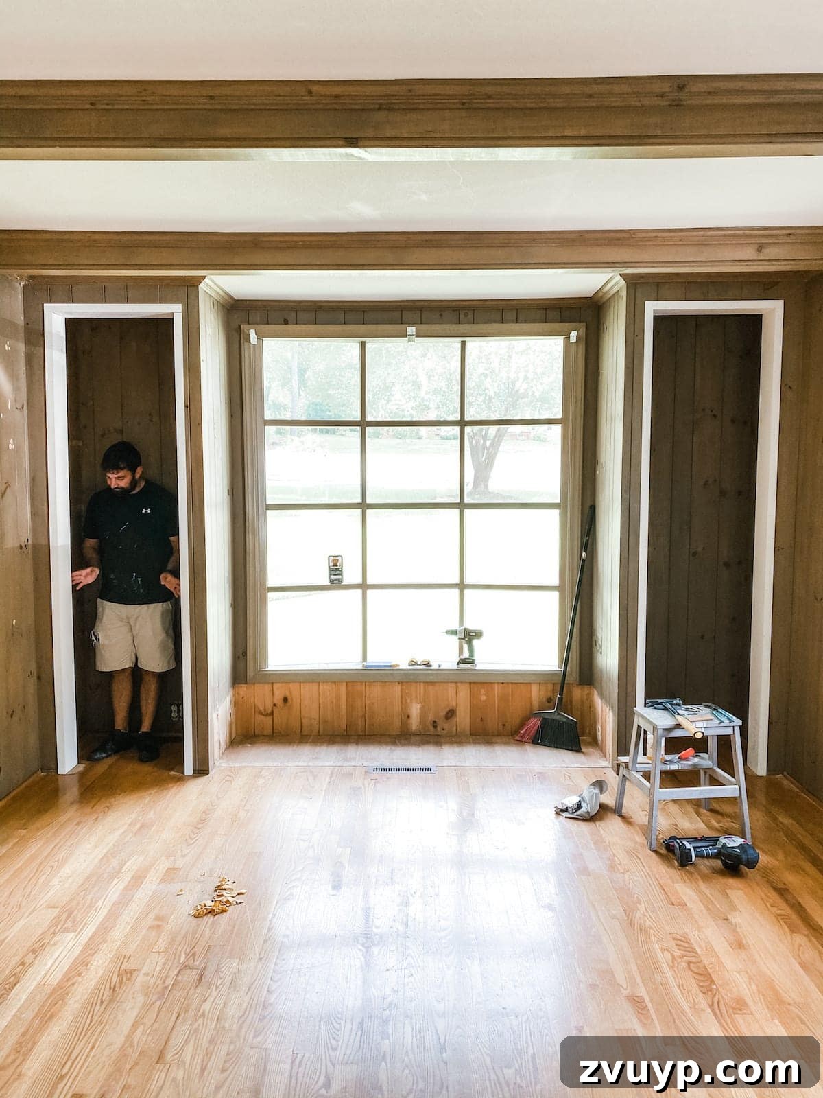 Transform Closets into Seamless Built-In Shelving 13 Sanding the filled and caulked wood frame of the converted closet