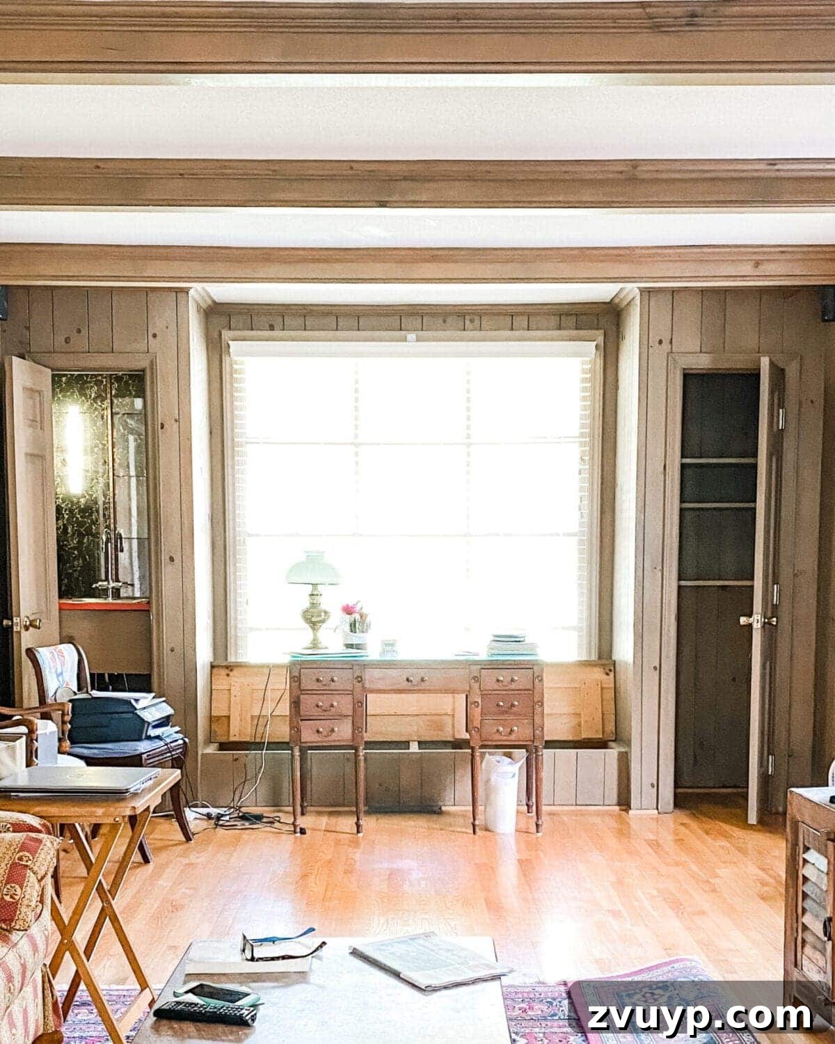 Transform Closets into Seamless Built-In Shelving 20 Living room office before transformation, showing dated wood paneling and closets