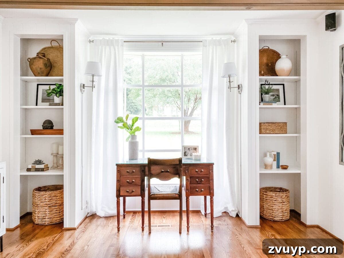 Transform Closets into Seamless Built-In Shelving 3 Modern white office in living room with custom built-in shelves and a clean desk in front of a window