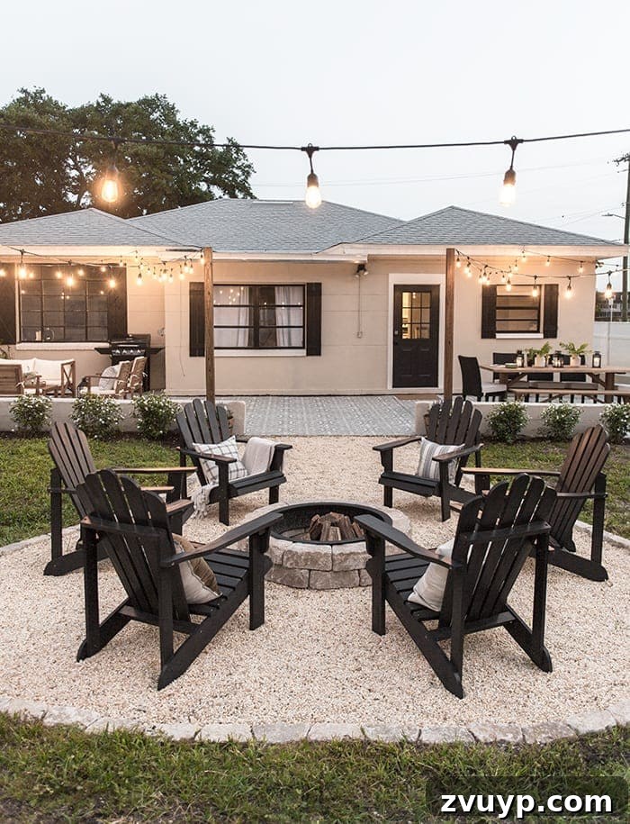 Elevate Your Outdoor Space: 15 Stunning Fire Pit Designs 14 Rustic backyard fire pit illuminated by string lights, with the ground covered in attractive pea gravel.