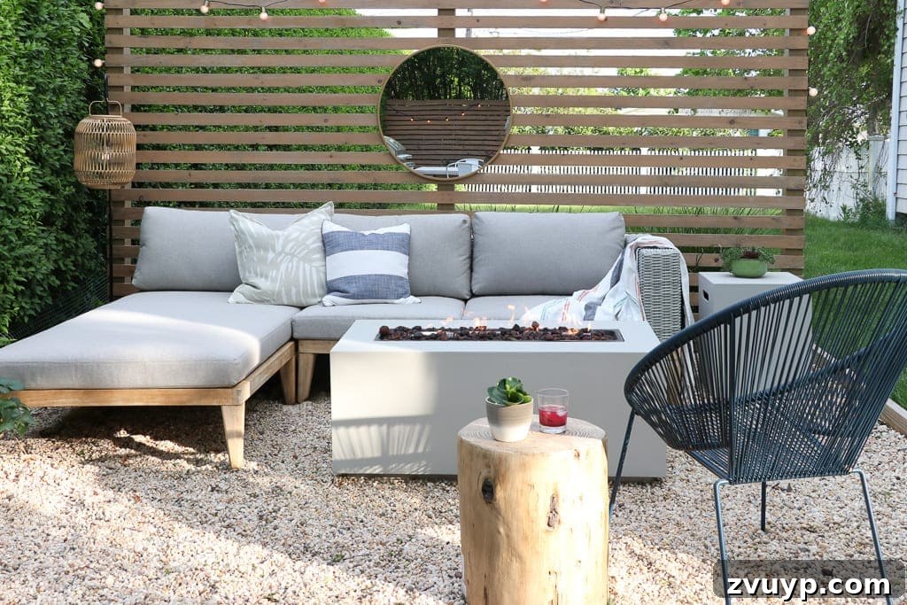 Elevate Your Outdoor Space: 15 Stunning Fire Pit Designs 6 Contemporary fire pit setup with a comfortable sectional and a stylish wood slat screen.