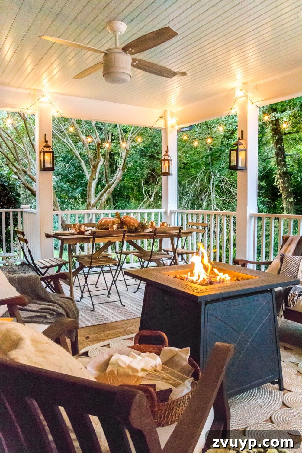 Elevate Your Outdoor Space: 15 Stunning Fire Pit Designs 7 Cozy back porch featuring a propane fire pit, decorative lanterns, and ambient string lights for a warm atmosphere.
