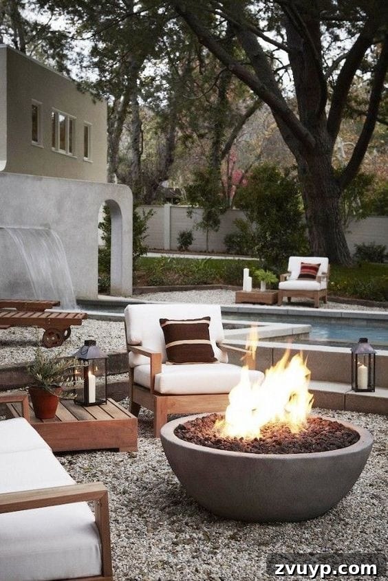 Elevate Your Outdoor Space: 15 Stunning Fire Pit Designs 9 Inviting backyard fire pit area designed with pea gravel, situated elegantly poolside.