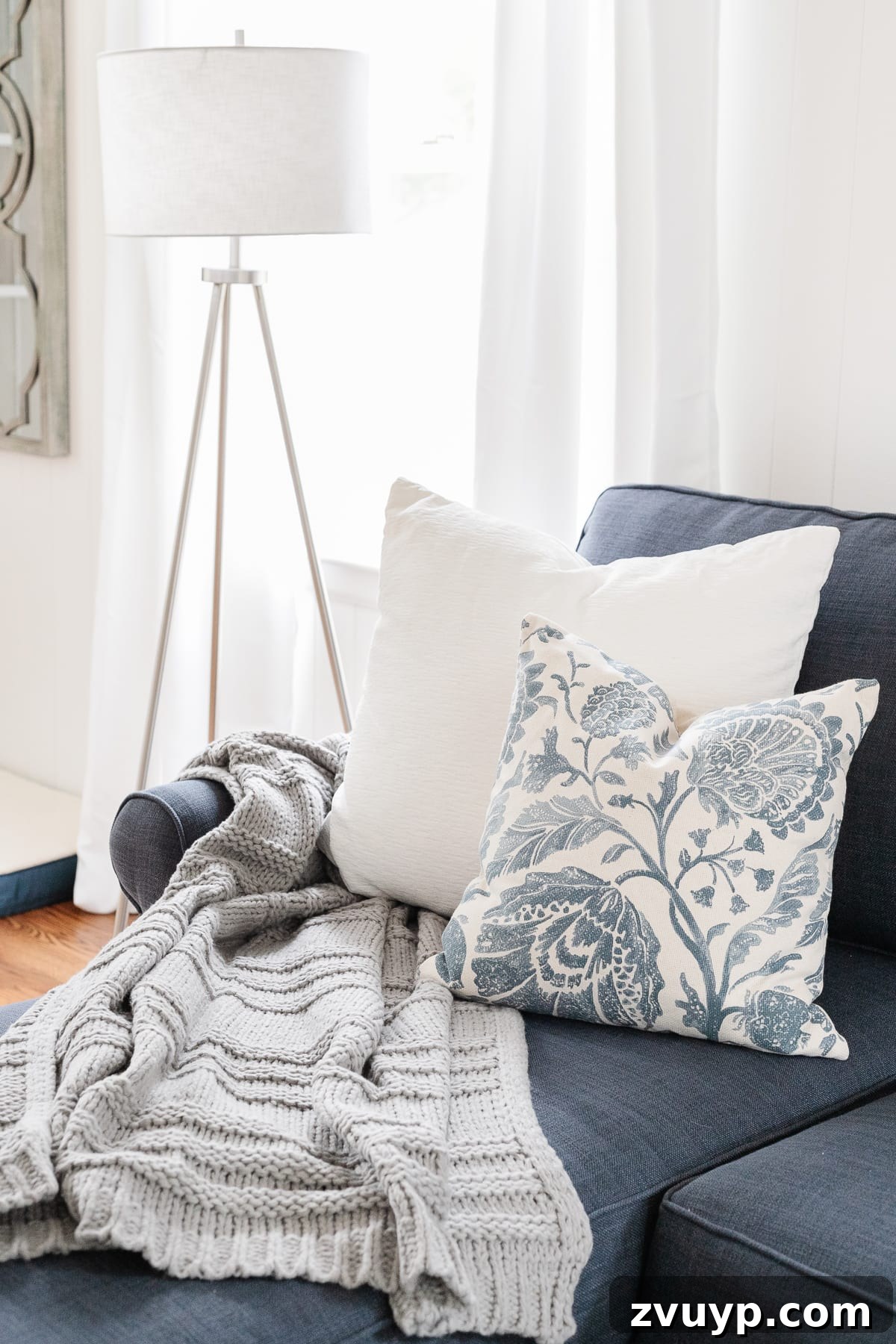Effortless Throw Pillow Styling 4 Coastal style living room sofa adorned with a variety of throw pillows, showcasing diverse textures and colors