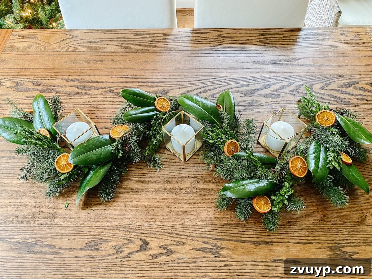 Crafting Natural Christmas Decor from Dried Fruit and Preserved Leaves 13 Adding dried orange slices to a Christmas garland already adorned with magnolia and boxwood