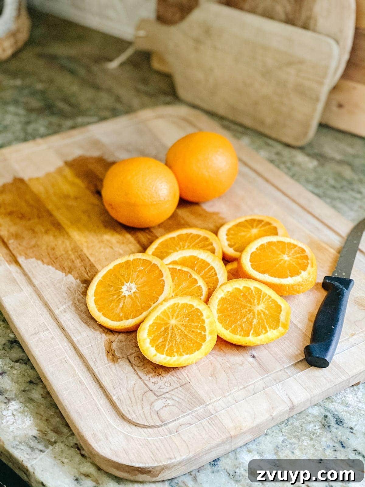 Crafting Natural Christmas Decor from Dried Fruit and Preserved Leaves 6 Fresh orange slices laid out on parchment paper, ready for drying to become Christmas decor