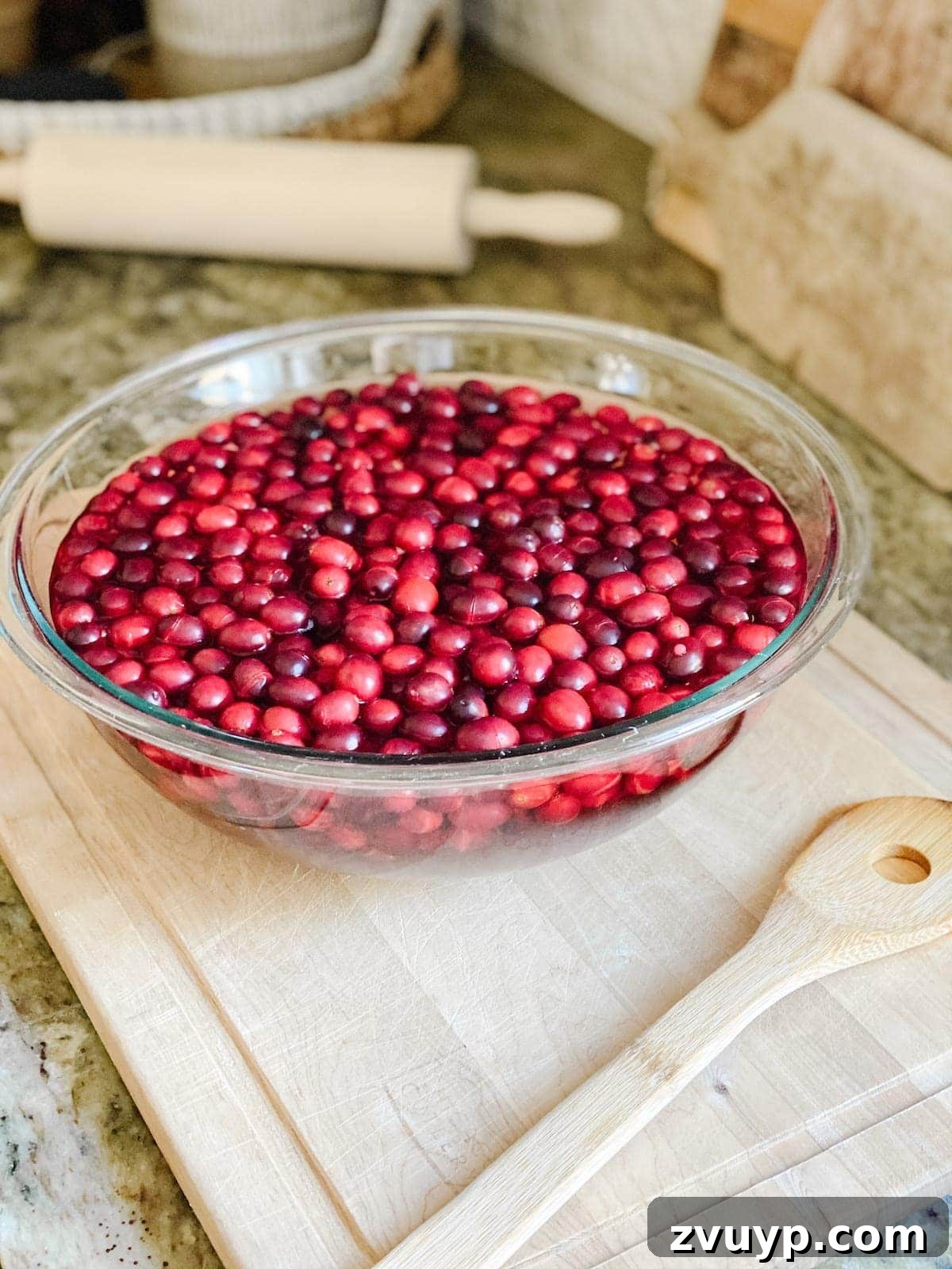Crafting Natural Christmas Decor from Dried Fruit and Preserved Leaves 8 Fresh cranberries soaking in hot water to prepare them for drying