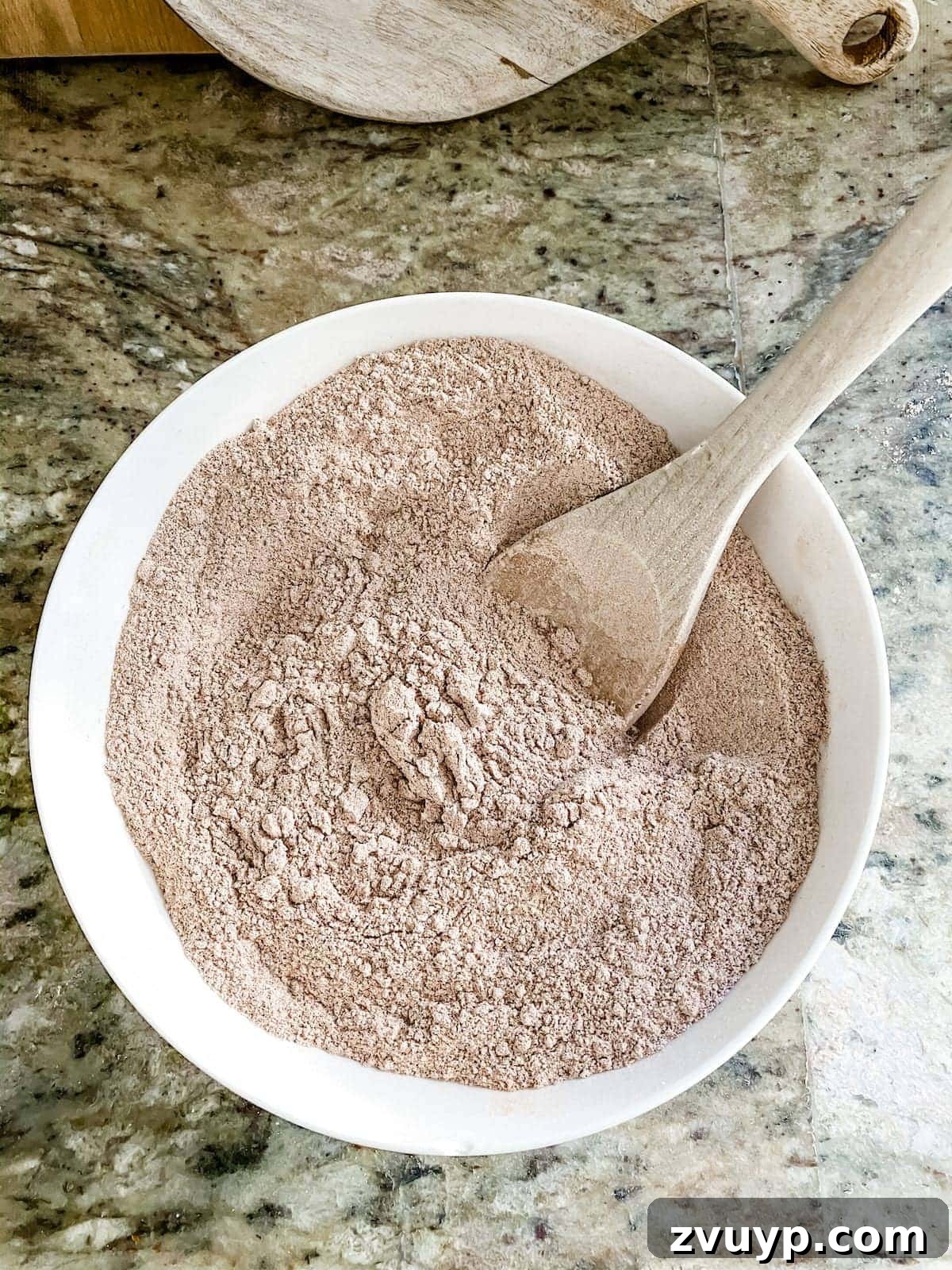 Craft Your Own Cinnamon Salt Dough Decorations 6 Mixing dry ingredients: flour, cinnamon, and salt in a bowl for cinnamon salt dough ornaments.