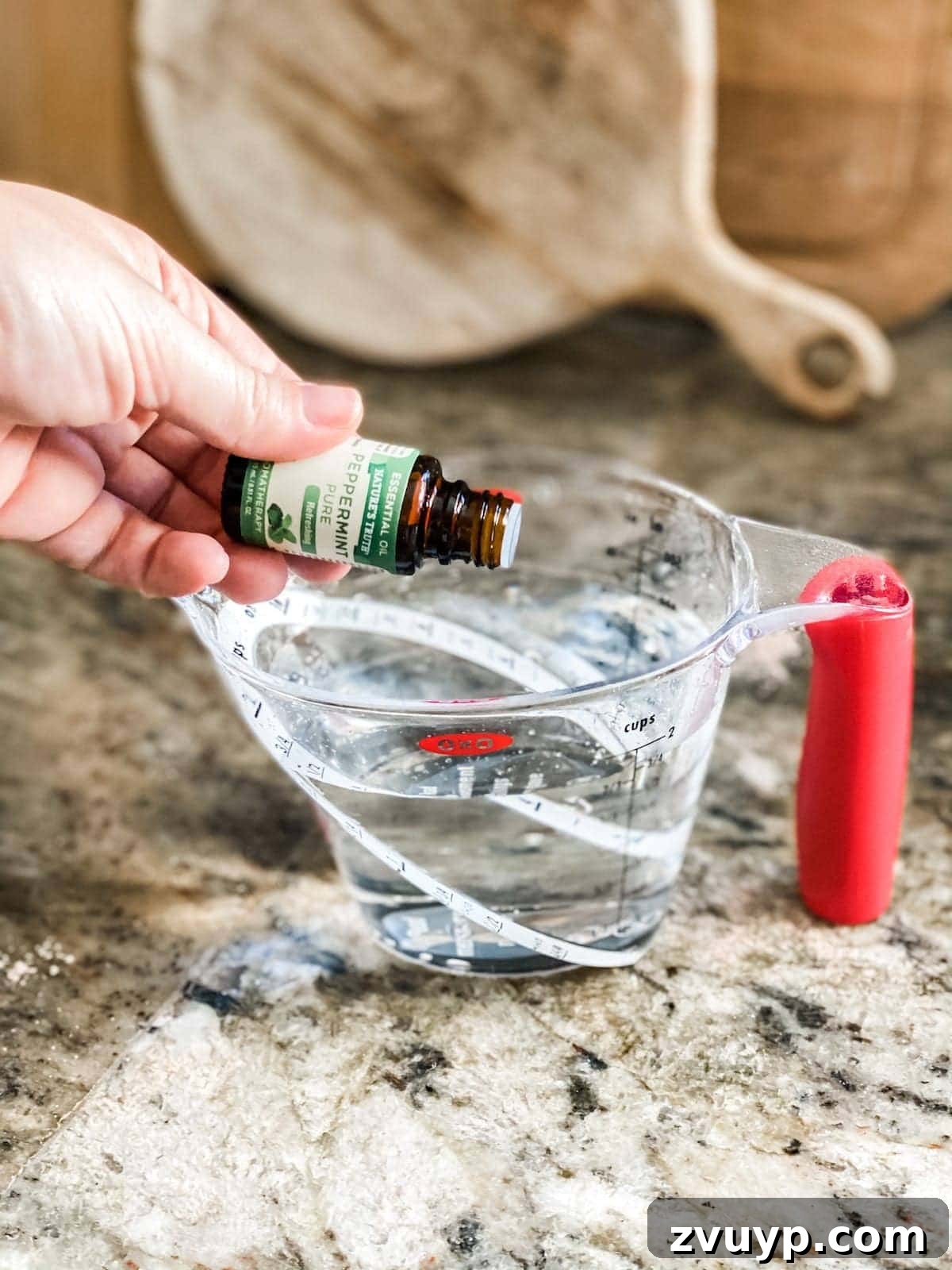 Craft Your Own Cinnamon Salt Dough Decorations 7 Adding essential oil to water, a key step for fragrant DIY cinnamon salt dough ornaments.