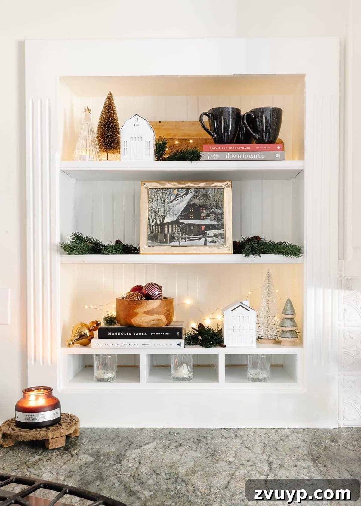 Christmas kitchen shelf with decor, vintage art, and fairy lights