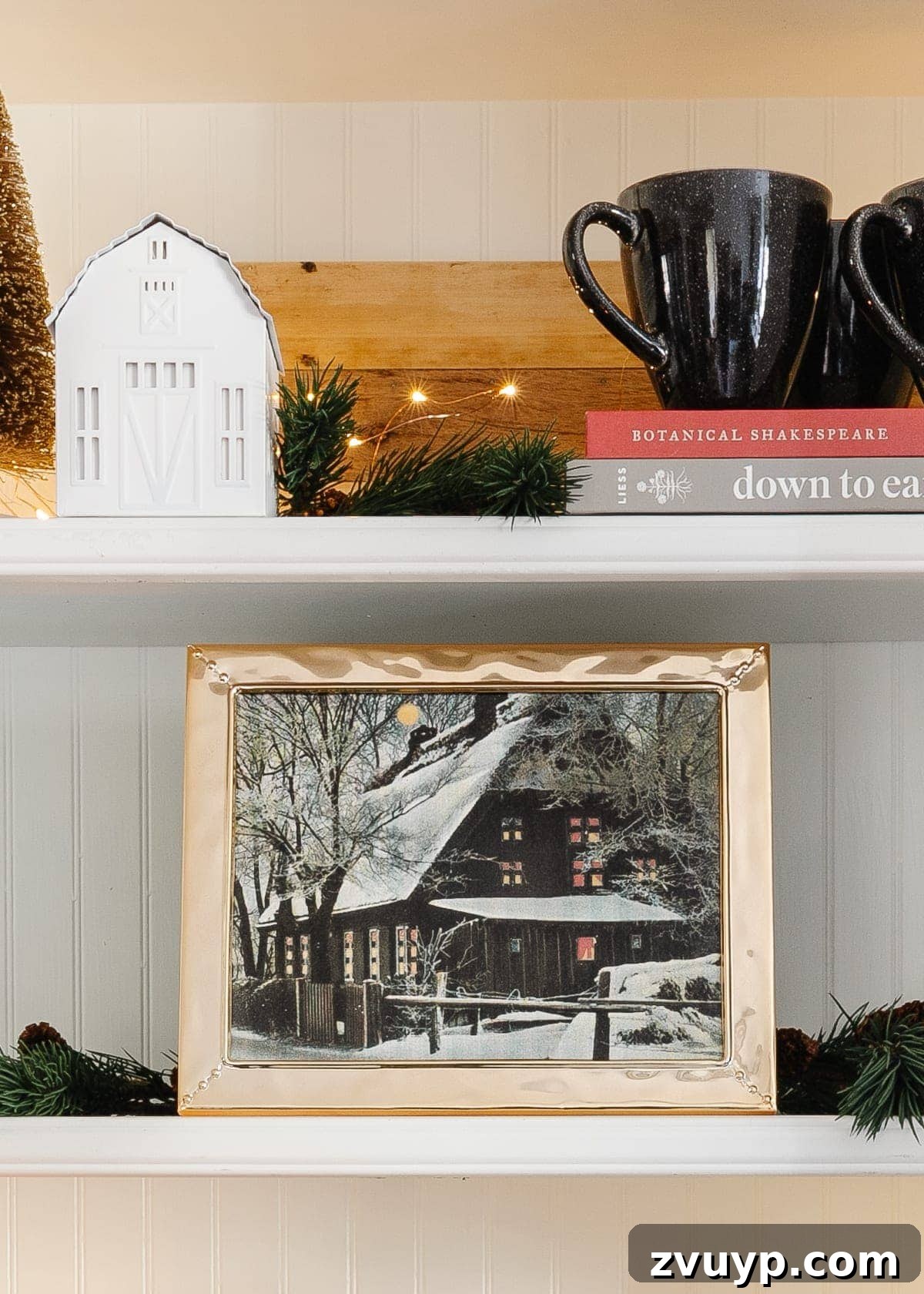 snow cabin art printable displayed on a kitchen shelf