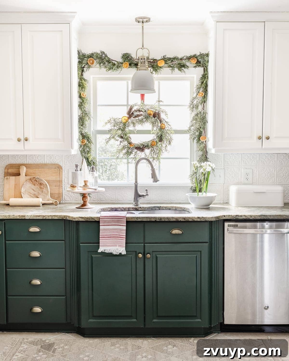 Christmas window kitchen decor behind a sink with garland and wreath
