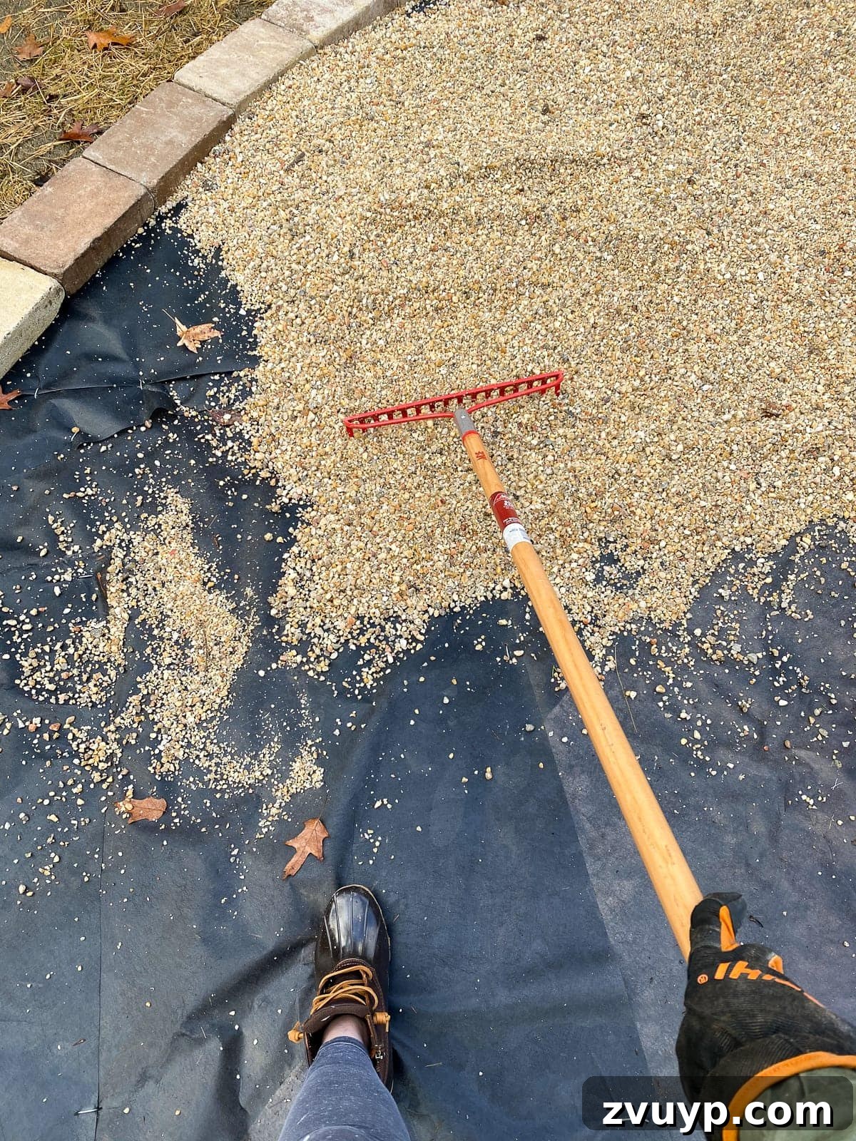 Weekend Wonder: DIY Pea Gravel Fire Pit 18 Raking pea gravel smoothly over the landscape fabric for the finished fire pit patio.
